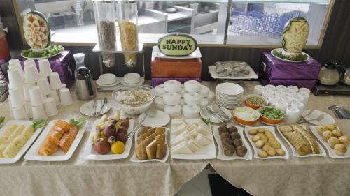 a table with many different types of food on it at Mayur Belgaum Presidency Hotel & Spa in Belgaum