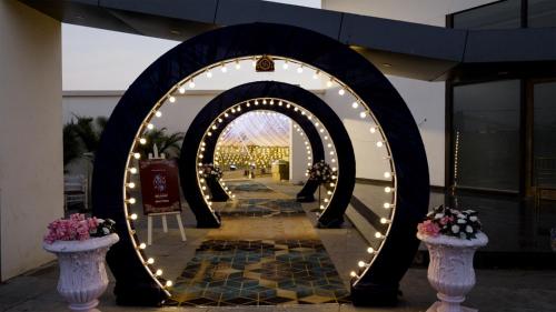 an archway with lights in the middle of a building at Mayur Belgaum Presidency Hotel & Spa in Belgaum