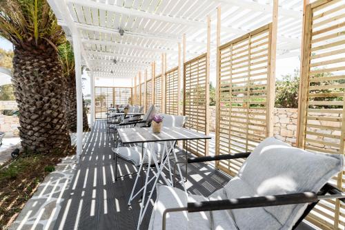 a row of tables and chairs on a patio at Pnoi Hotel in Logaras