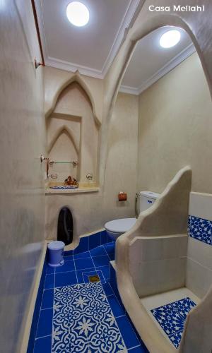 a bathroom with a toilet and a blue tile floor at Casa Meftah Blue in Chefchaouene