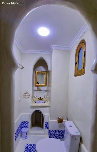 a white bathroom with a toilet and a sink at Casa Meftah Blue in Chefchaouene