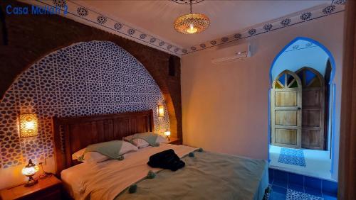 a bedroom with a bed and a window with a bag on it at Casa Meftah Blue in Chefchaouene