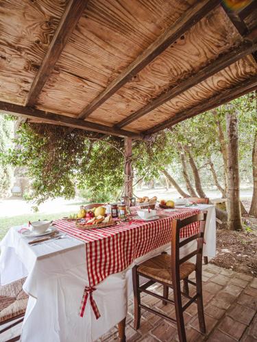 a table with a red and white checkered table cloth at Relais Casale Il Poggetto - I PINI by Zoom In Earth in Cecina