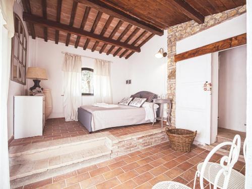 a bedroom with a bed and a table and chairs at Relais Casale Il Poggetto - I PINI by Zoom In Earth in Cecina