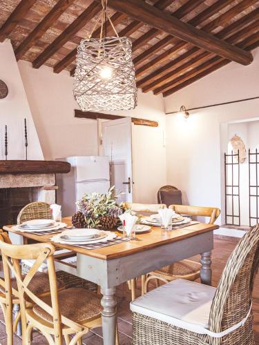 a dining room with a table and chairs at Relais Casale Il Poggetto - I PINI by Zoom In Earth in Cecina