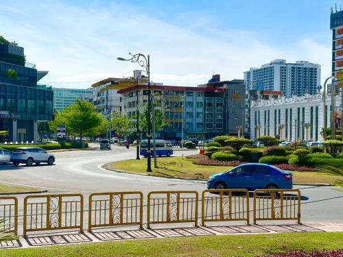 a city street with cars driving down a road at VALLEY HOTEL in Kota Kinabalu