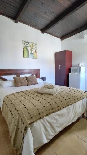 a bedroom with a large bed and a red cabinet at Posada Don Manuel in Paso de los Toros