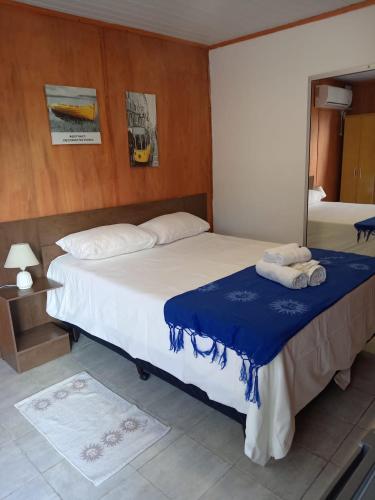 a bedroom with a large bed and a mirror at Posada Don Manuel in Santa Isabel
