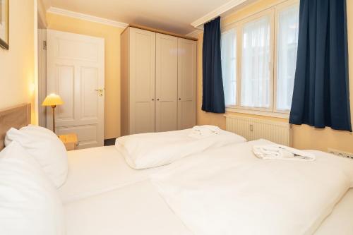 two white beds in a room with a window at Seehof Seehof 2 0 in Bansin