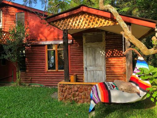 a small log cabin with a blanket in front of it at The Murana Chalet in Nanyuki