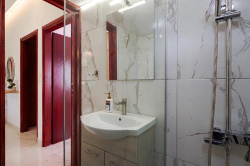 a bathroom with a sink and a glass shower at Entire vacation house near beach in Gournes