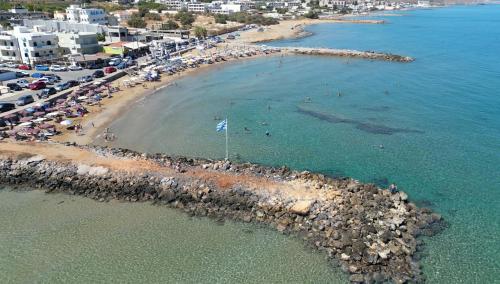 an aerial view of a beach with people in the water at Entire vacation house near beach in Gournes
