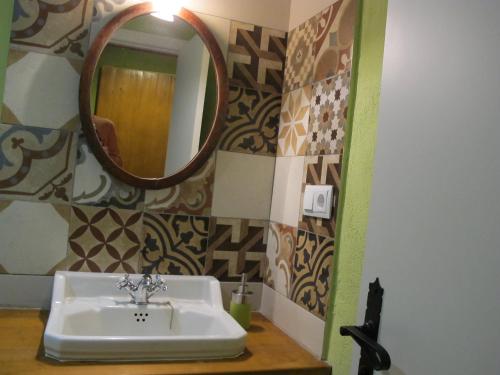 a bathroom with a sink and a mirror at Mas Can Puig de Fuirosos in Barcelona