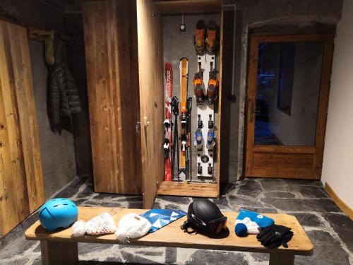 a group of helmets and ski gear sitting on a bench at Chez Léon in Samoëns