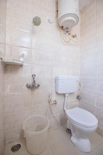 a bathroom with a toilet and a shower at JC Woodville Manor in Kodaikānāl