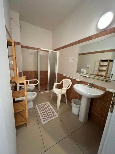 a bathroom with two toilets and a sink and a shower at Club Vacanze In in Cervia