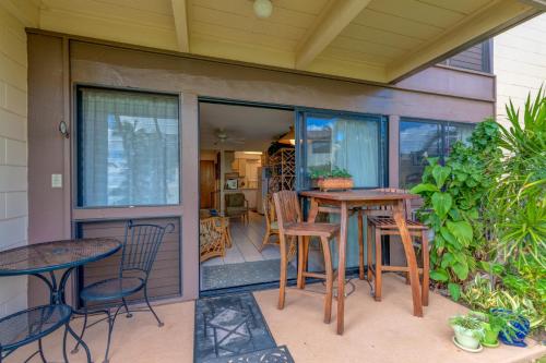 a patio with tables and chairs on a porch at Hono Kai A3 in Maalaea