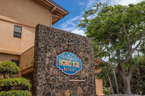 a sign for a hogan real estate sign on a building at Hono Kai A3 in Maalaea