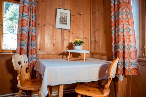a dining room with a table and two chairs at Landhaus Geierwally in Elbigenalp