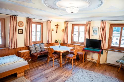 a living room with a table and a couch at Landhaus Geierwally in Elbigenalp