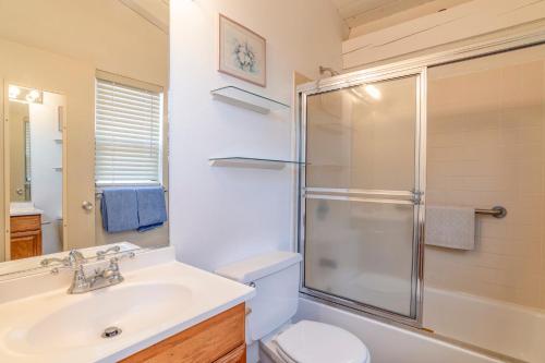a bathroom with a toilet and a sink and a shower at Hono Kai C12 in Maalaea