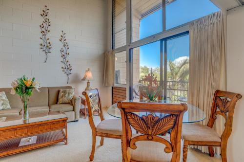a living room with a table and chairs at Hono Kai C8 in Wailuku