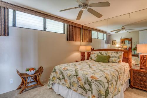 a bedroom with a bed and a ceiling fan at Papakea F105 in Lahaina
