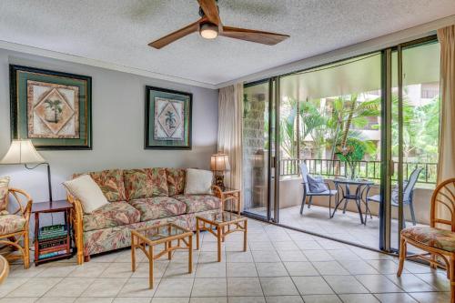 a living room with a couch and a table at Paki Maui 211 in Kahana