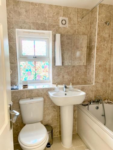 uma casa de banho com um WC, um lavatório e uma banheira em Gillingham Homestay Monday to Friday Female only em Hoo