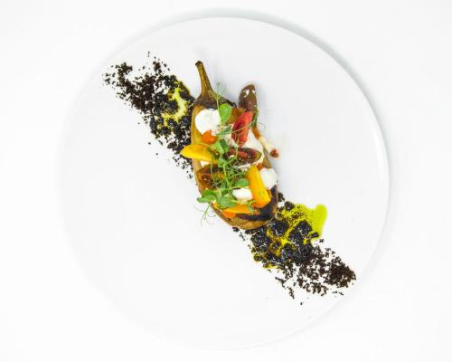 a plate of food with vegetables on a white plate at Villa Val Lemme - Albergo Ristorante in Francavilla Bisio