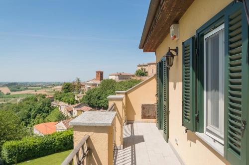 a balcony of a house with green shutters at MONFERRATO HILLS Charming Garden Villa in Vignale Monferrato