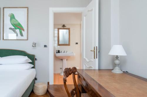 a bedroom with a bed and a bathroom with a sink at MONFERRATO HILLS Charming Garden Villa in Vignale Monferrato