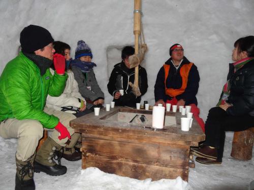 a group of people sitting in a room in the snow at Nakaodaira in Takayama