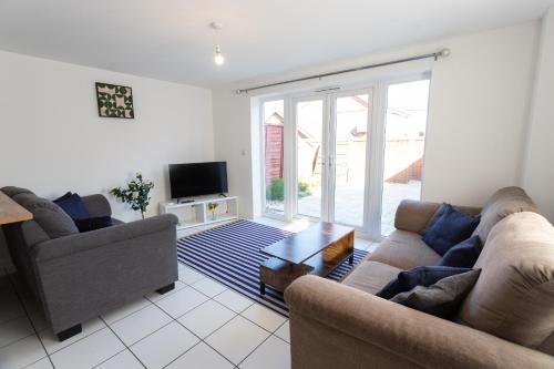a living room with two couches and a tv at April Disc - Long Stay - Contractors in Bristol