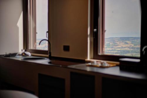 a kitchen with two windows and a counter top at Montepagano 1137 in Montepagano