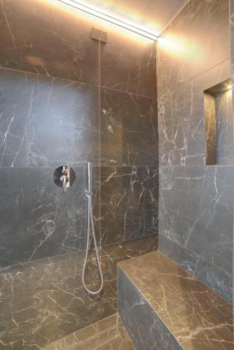 a bathroom with a shower with a black wall at Montepagano 1137 in Montepagano