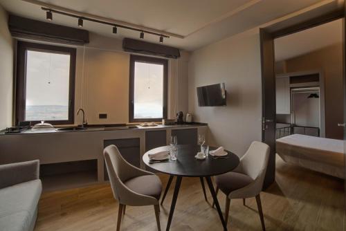 a room with a table and chairs and a bed at Montepagano 1137 in Montepagano