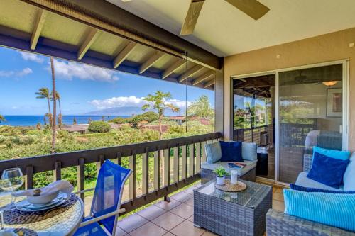 a balcony with chairs and a table and a view of the ocean at Kaanapali Plantation 54 in Lahaina