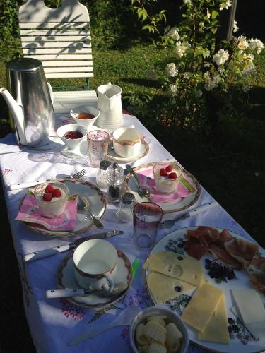 a table with plates of food on top of it at All Seasons Bed & Breakfast in Kerpen
