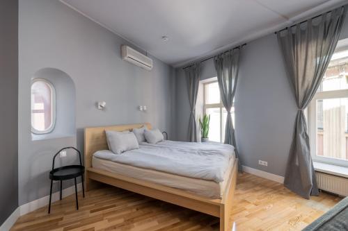 a bedroom with a bed and a large window at Romantic and spacious apartment in Riga Old Town in Rīga