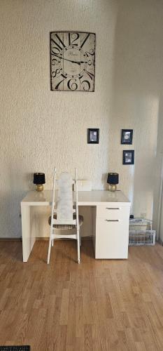 a white desk with a chair next to a wall at Anisa in Vir