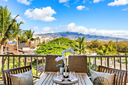 a table on a balcony with a view of a city at Nani Kai Hale 404 in Kihei
