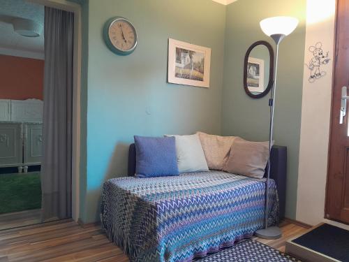 ein Zimmer mit einem Sofa und einer Uhr an der Wand in der Unterkunft Apartment Süd in Sankt Pölten