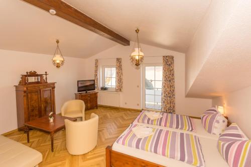 a bedroom with a bed and a desk and a chair at Pension Anker in Binz