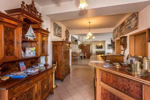 a kitchen with wooden cabinets and a counter top at Pension Anker in Binz