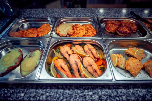 a tray of food with seafood and other foods at Hotel Centrum Malbork in Malbork
