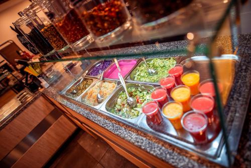 a buffet with a variety of salads and drinks at Hotel Centrum Malbork in Malbork