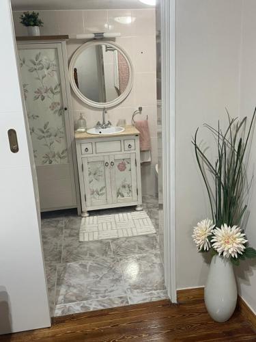 a bathroom with a sink and a mirror at Casa Mariyina in Ribadesella