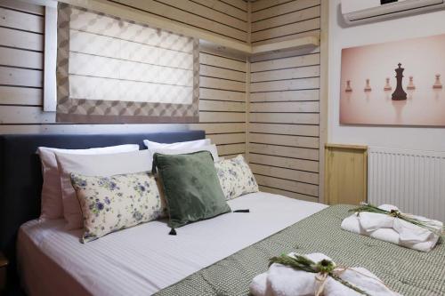 a bedroom with a bed with pillows and a window at Villa Ftelia Oasis,Skiathos in Megali Ammos