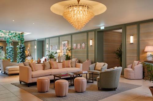 a lobby with couches and chairs and a chandelier at The Gleneagles Hotel in Auchterarder